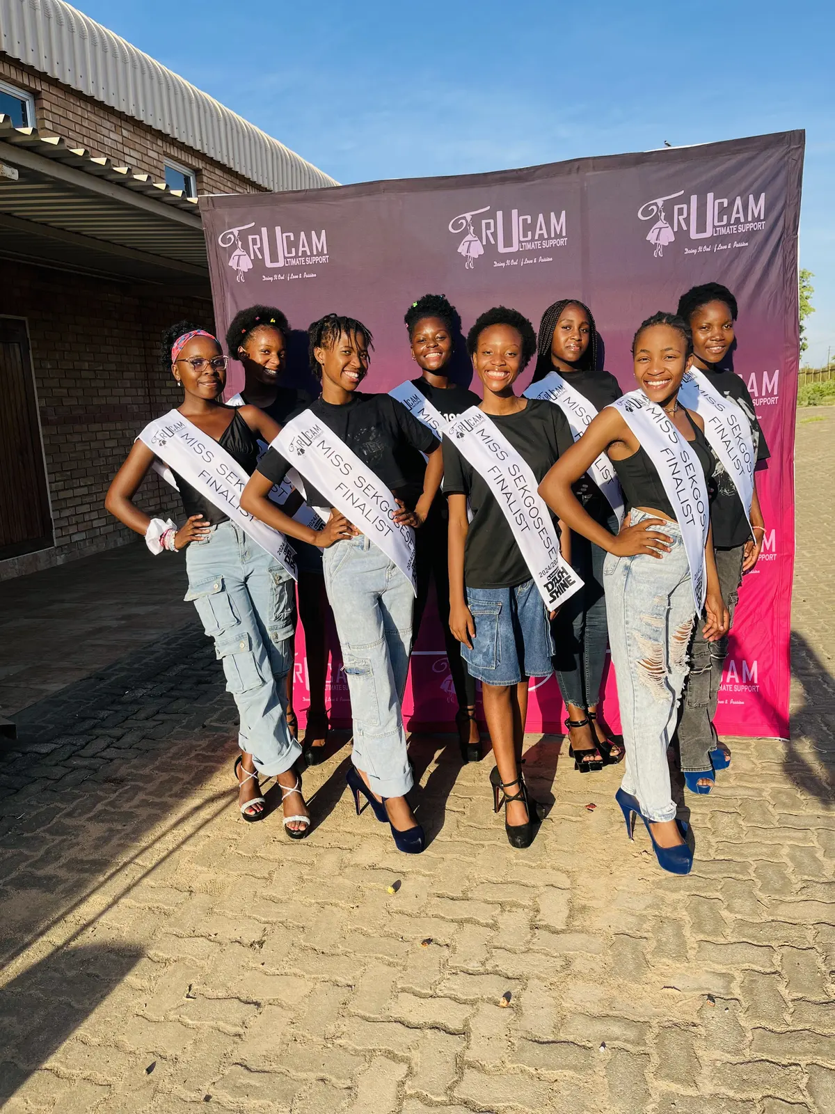 Miss Sekgosese contestants posing in front of the TruCam banner