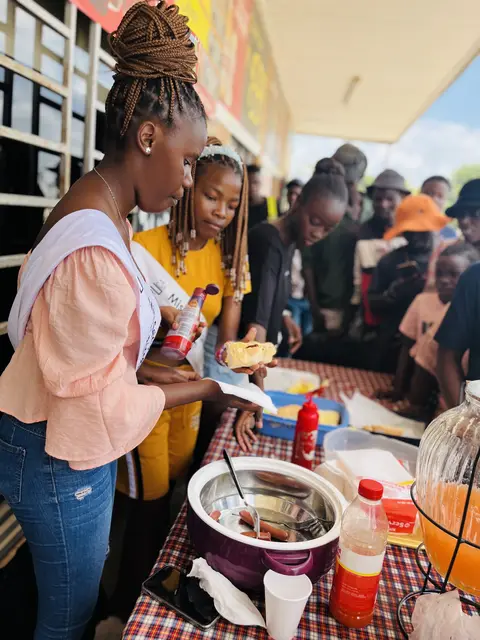 Volunteers dishing up hot meals at a community feeding day