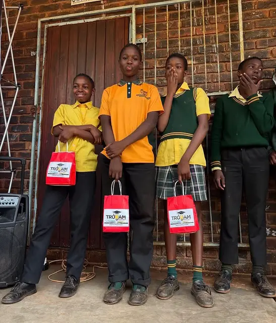 Achieving learners proudly holding their TruCam gift bags